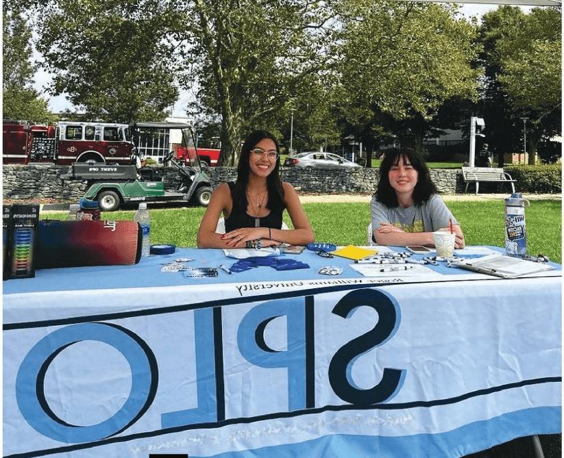 Students sitting at Student Programs Table at Involvement Fair